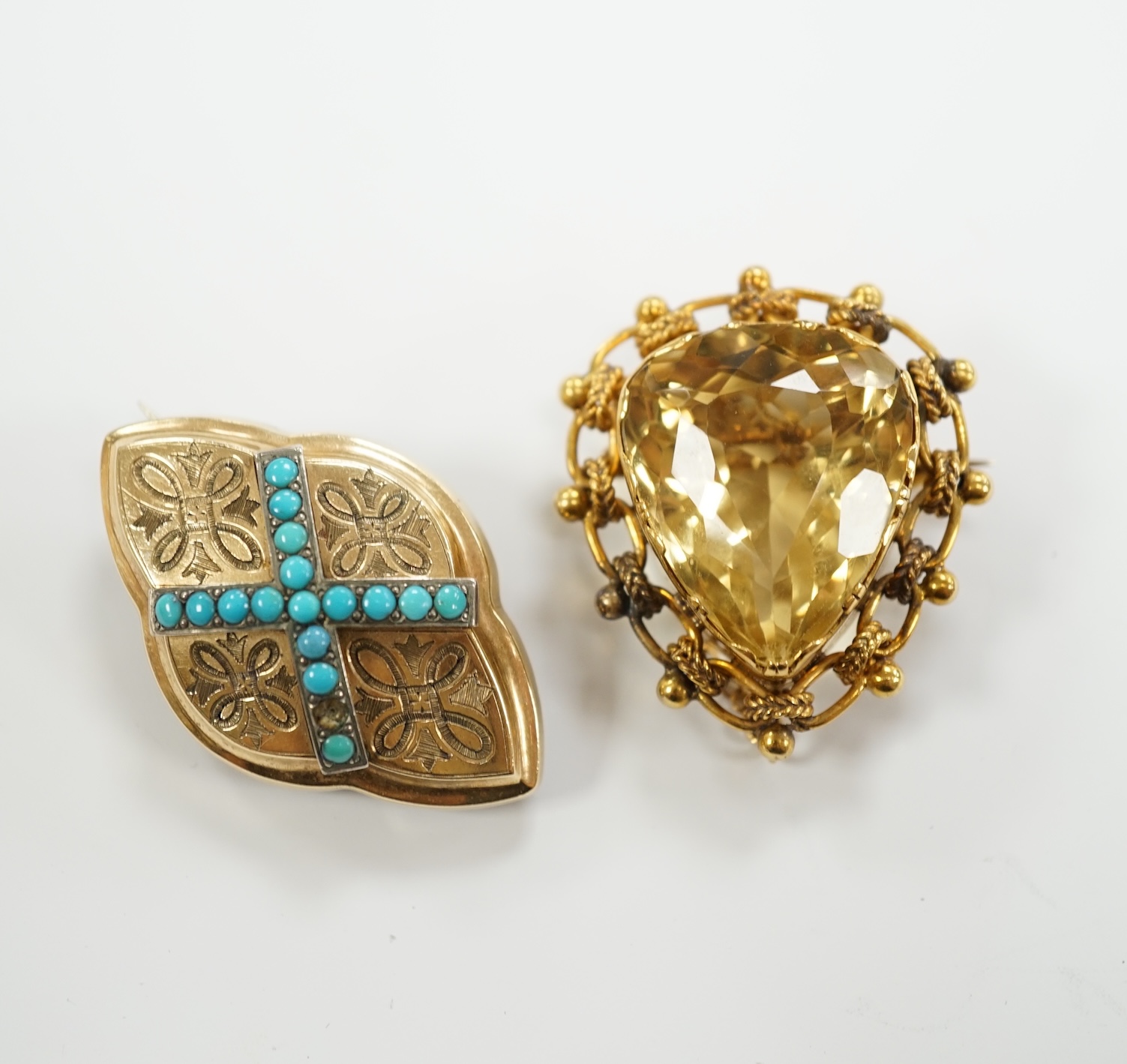 An Edwardian yellow metal mounted single stone pear cut citrine set brooch, 37mm and an earlier yellow metal and turquoise set lozenge shaped brooch, gross weight 23.9 grams.